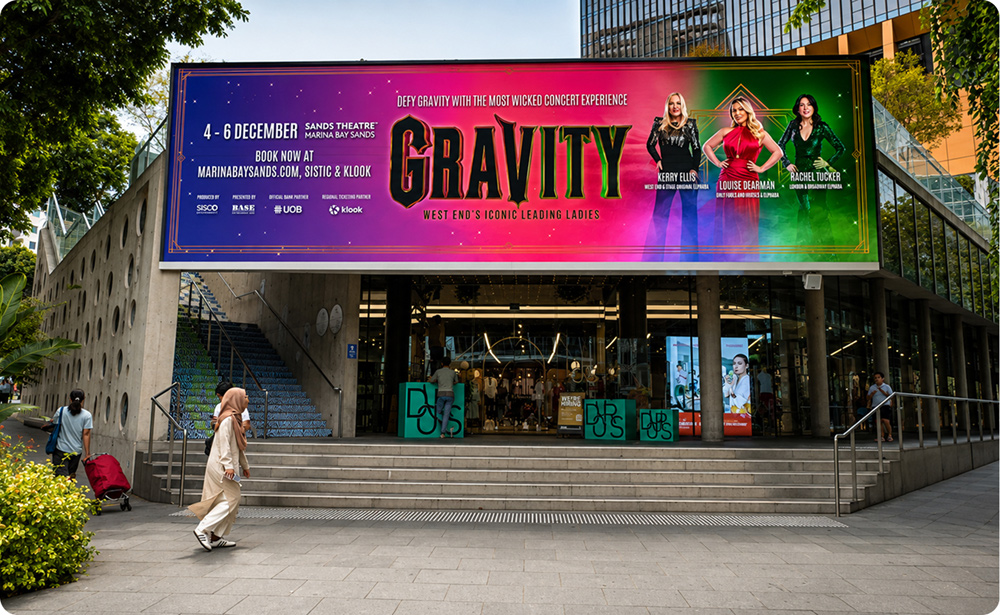 Design Orchard large-format LED screen on Orchard Road, Singapore, showing a GRAVITY concert ad