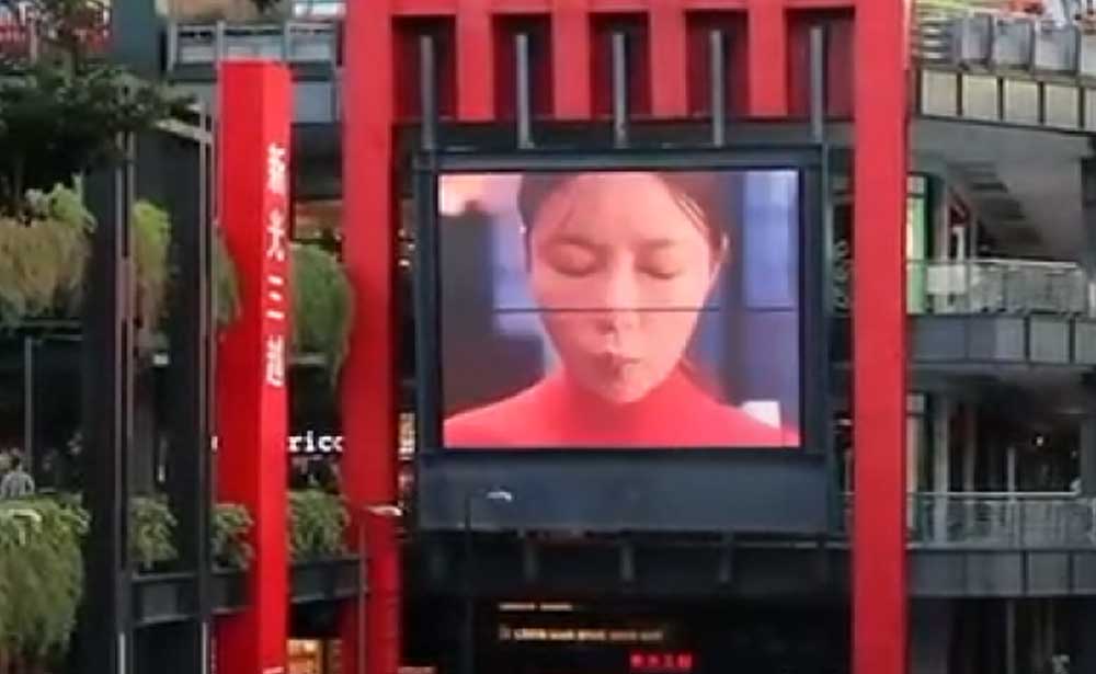 K-Food video campaign on a large LED screen set within a red architectural frame at a retail complex in Taiwan