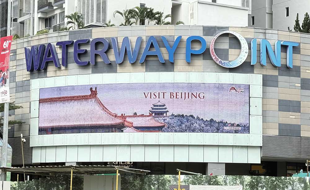 Visit Beijing tourism campaign on the wide LED screen above the Waterway Point mall entrance