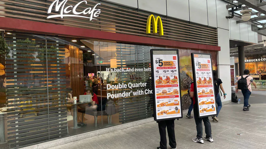 PosterWalker™ talents promoting McDonald’s $5 Super Savers outside a McCafé in Singapore